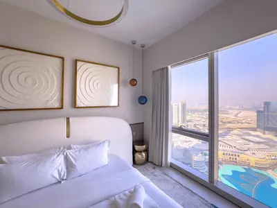 a bedroom with a bed and a large window at GRANDE SIGNATURE with a direct Burj Khalifa view and Private Fountain Show at 62nd floor with DXB AIRPORT VIP Shuttle option for 6 guests in Dubai