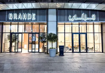 a grand entrance to a store with large glass doors at GRANDE SIGNATURE with a direct Burj Khalifa view and Private Fountain Show at 62nd floor with DXB AIRPORT VIP Shuttle option for 6 guests in Dubai