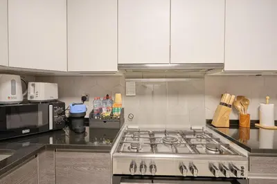 a kitchen with a stove and a microwave at Luxury 1BR Downtown Modern Urban Stay in Dubai