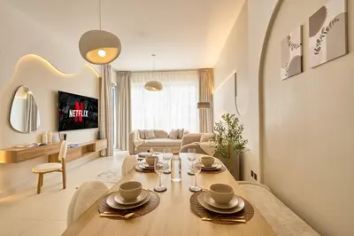 a living room with a dining table and a living room at Luxury 1BR Downtown Modern Urban Stay in Dubai