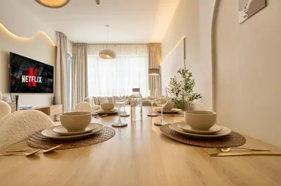 a dining room table with chairs and a dining room at Luxury 1BR Downtown Modern Urban Stay in Dubai