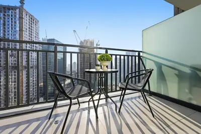 a balcony with two chairs and a table on a balcony at Zada 1BR High Floor - Stunning View 1min Downtown and 2min to Metro in Dubai