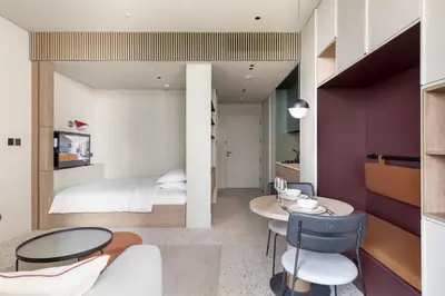 a bedroom with a bed and a table and chairs at Executive Studio in Business Bay with Working Area, Pool, Gym in Dubai