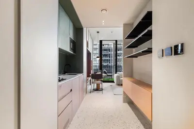 a kitchen with white cabinets and a sink at Executive Studio in Business Bay with Working Area, Pool, Gym in Dubai