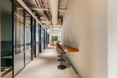 a corridor of an office with desks and windows at Executive Studio in Business Bay with Working Area, Pool, Gym in Dubai