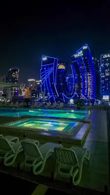 a view of a city skyline at night at Stylish Dubai Stay in Dubai