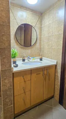 a bathroom with a sink and a mirror at Stylish Dubai Stay in Dubai