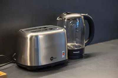 a toaster sitting on a counter next to a blender at Skyline Views with Waterfront & Marina Walk - 3 BDR Apartment in Dubai