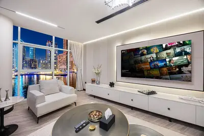 a living room with a large tv on the wall at Skyline Views with Waterfront & Marina Walk - 3 BDR Apartment in Dubai