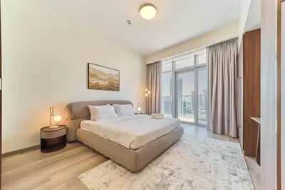 a bedroom with a large bed and a large window at fam Living Ultra Luxury 3BR Burj Khalifa View in Dubai