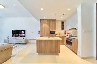 a large kitchen with a large island in the middle at fam Living Ultra Luxury 3BR Burj Khalifa View in Dubai