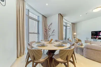 a living room with a table and chairs and a couch at fam Living Ultra Luxury 3BR Burj Khalifa View in Dubai