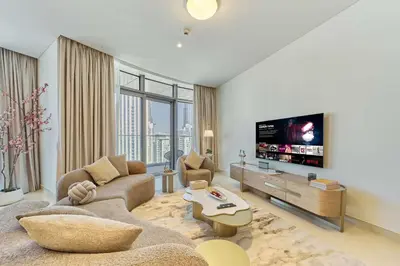 a living room with a couch and a tv at fam Living Ultra Luxury 3BR Burj Khalifa View in Dubai