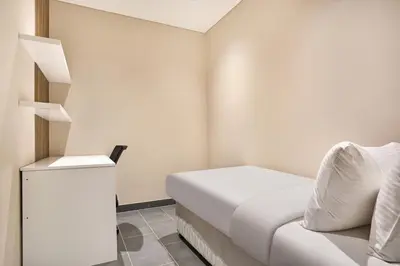 a small room with a bed and a white cabinet at STAY BY LATINEM Luxury 1BR Plus Holiday Home CB 1412 Near Burj Khalifa in Dubai
