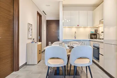a kitchen with a table and four chairs at STAY BY LATINEM Luxury 1BR Plus Holiday Home CB 1412 Near Burj Khalifa in Dubai