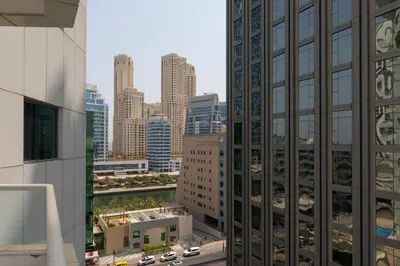a view of a city skyline with tall buildings at Deluxe Ensuite Room with Balcony & Twin Beds in Dubai