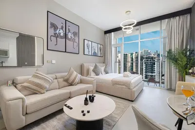 a living room with a couch and a table at Stylish Studio Business Bay Near Dubai Mall in Dubai