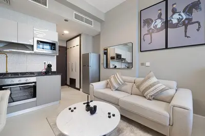a living room with a couch and a table at Stylish Studio Business Bay Near Dubai Mall in Dubai