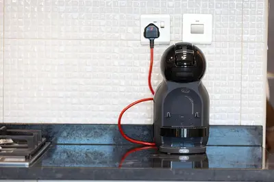 a coffee maker plugged into an electrical outlet at Stylish Studio Business Bay Near Dubai Mall in Dubai