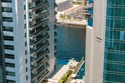 an aerial view of a river between two tall buildings at Stylish Studio Business Bay Near Dubai Mall in Dubai