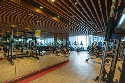 a gym with tread machines and people exercising in it at Stylish Studio Business Bay Near Dubai Mall in Dubai