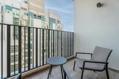 a balcony with two chairs and a table at GuestReady - 1BR l Stylish 10th-Floor Retreat in Dubai