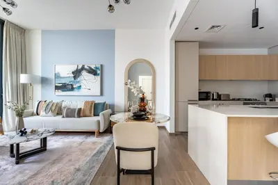 a kitchen and living room with a couch and a table at GuestReady - 1BR l Stylish 10th-Floor Retreat in Dubai