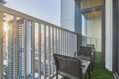 a balcony with a chair and a view of the city at STAY BY LATINEM Luxury 1BR Holiday Home CC 3007 Near Burj Khalifa in Dubai