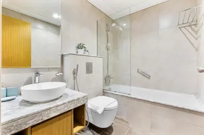 a bathroom with a sink and a toilet and a shower at Modern 2Bed with Canal Views 7 Mins to Burj Khalifa in Dubai