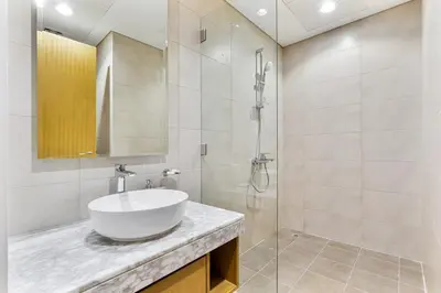 a bathroom with a white sink and a shower at Modern 2Bed with Canal Views 7 Mins to Burj Khalifa in Dubai