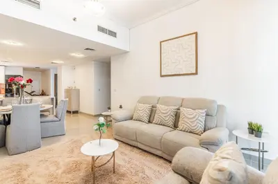 a living room with a couch and a table at RH- Marina Living- Chic Ocean Heights 3BR with Panoramic Views in Dubai