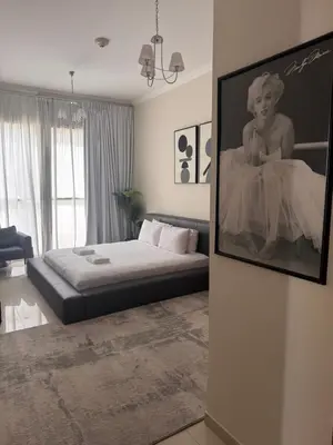 a bedroom with a bed and a picture of a woman at Prime Downtown 3 BDR-2 mn to Dubai Mall in Dubai