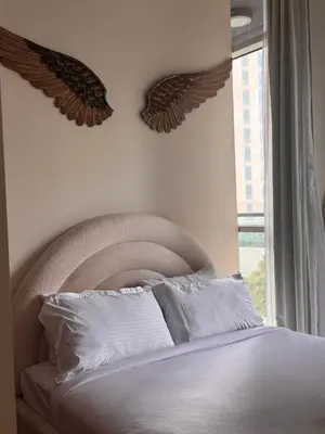 a bedroom with a bed with a headboard and a window at Prime Downtown 3 BDR-2 mn to Dubai Mall in Dubai
