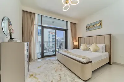 a bedroom with a bed and a large window at fam Living Chic 1BR Retreat in Dubai Hills Estate in Dubai