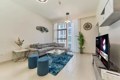 a living room with a couch and a tv at fam Living Chic 1BR Retreat in Dubai Hills Estate in Dubai