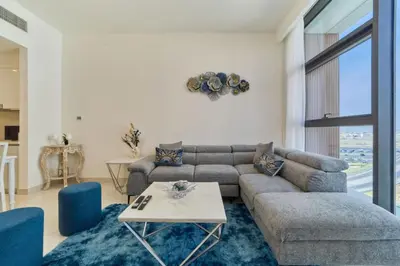 a living room with a couch and a table at fam Living Chic 1BR Retreat in Dubai Hills Estate in Dubai