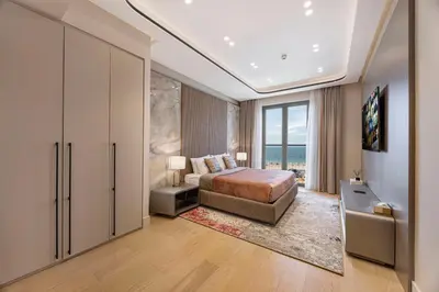 a bedroom with a bed and a large window at Daniels 3BR at La Cote with Full Sea View in Dubai