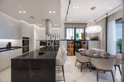 a kitchen with a table and a dining room at Daniels 3BR at La Cote with Full Sea View in Dubai