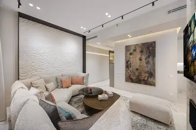 a living room with a couch and a table at Daniels 3BR at La Cote with Full Sea View in Dubai