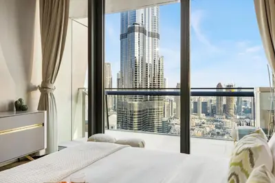 a bedroom with a bed and a large window at 3BR Direct Access to Dubai Mall and Burj Khalifa in Dubai