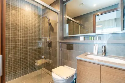 a bathroom with a shower and a toilet and a sink at HAVN - 1 bedroom in The Crest, Skyline Views in Dubai