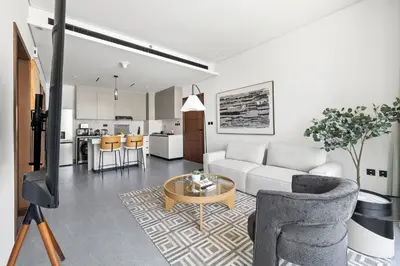 a living room with a couch and a table at Modern 1BR Near World Trade Center Metro in Dubai