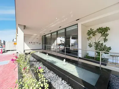 an external view of a building with a swimming pool at Modern 1BR Near World Trade Center Metro in Dubai