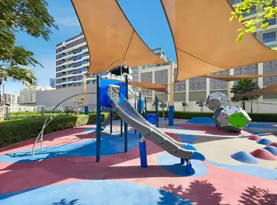 an outdoor playground with a slide and a slideintend at Modern 1BR Near World Trade Center Metro in Dubai