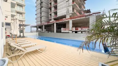 a building under construction with a swimming pool on a building at Escape24 Chic 1BR in Al Furjan near Metro in Dubai