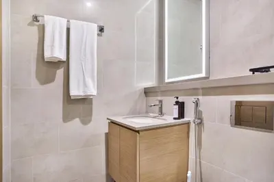 a bathroom with a sink and a mirror at STAY BY LATINEM Luxury 2BR Holiday Home W2013 near Downtown in Dubai