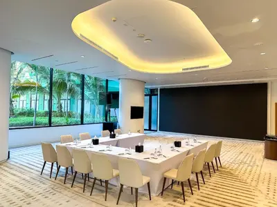 a conference room with a large white table and chairs at voco Dubai Nice The Heart of Europe by IHG in Dubai