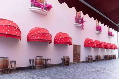 a group of red umbrellas on a wall with drums at voco Dubai Nice The Heart of Europe by IHG in Dubai