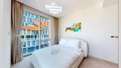 a bedroom with a white bed and a large window at Vacationer l 2 Bed Direct Dubai Mall Access l Free Pool, Gym in Dubai