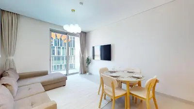 a living room with a table and a couch at Vacationer l 2 Bed Direct Dubai Mall Access l Free Pool, Gym in Dubai